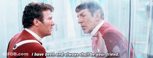Two Men Are Standing Next To Each Other And Talking To Each Other . GIF