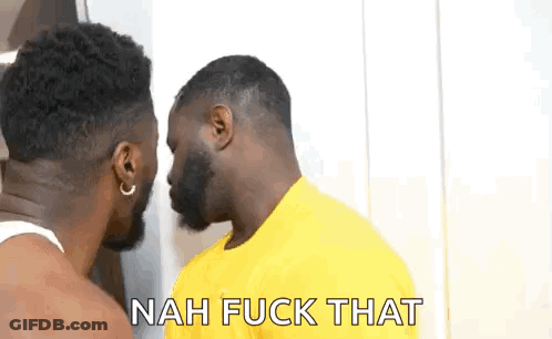 Two Men Are Standing Next To Each Other And Talking To Each Other . One Of The Men Is Wearing A Yellow Shirt . GIF