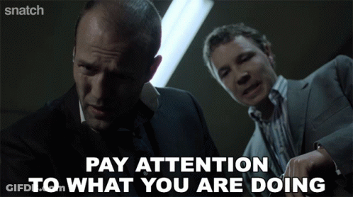 Two Men Are Standing Next To Each Other And The Words Pay Attention To What You Are Doing GIF
