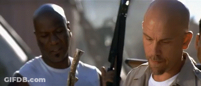 Two Men Are Standing Next To Each Other Holding Guns GIF