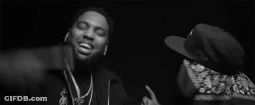 Two Men Are Standing Next To Each Other In A Black And White Photo . One Of The Men Is Wearing A Bandana . GIF