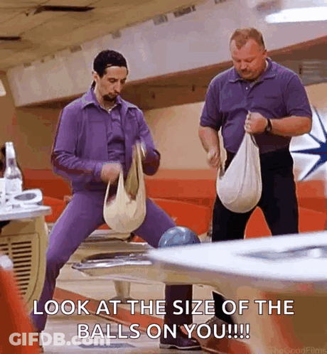 Two Men Are Standing Next To Each Other In A Bowling Alley And Holding Bags . GIF