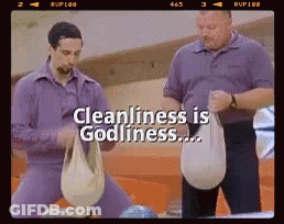 Two Men Are Standing Next To Each Other In A Bowling Alley With The Words Cleanliness Is Godliness Above Them GIF