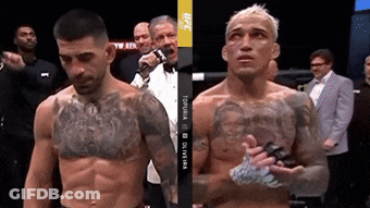 Two Men Are Standing Next To Each Other In A Boxing Ring And One Of Them Has A Tattoo On His Chest .. GIF