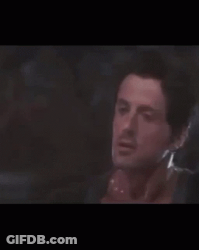 Two Men Are Standing Next To Each Other In A Boxing Ring . GIF