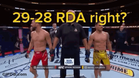 Two Men Are Standing Next To Each Other In A Boxing Ring With The Words 29-28 Rda Right Written Above Them GIF