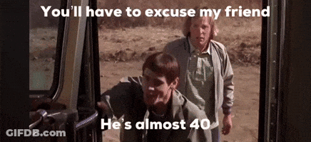 Two Men Are Standing Next To Each Other In A Car Doorway . GIF