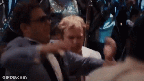 Two Men Are Standing Next To Each Other In A Crowd . GIF