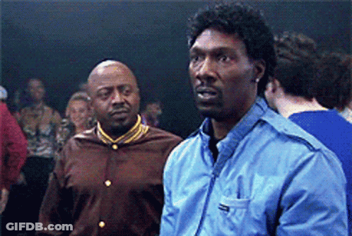 Two Men Are Standing Next To Each Other In A Crowd And One Of Them Is Wearing A Blue Jacket With The Word Reebok On It GIF