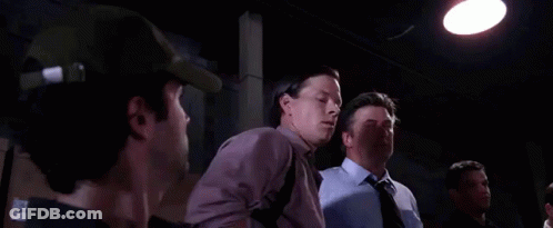 Two Men Are Standing Next To Each Other In A Dark Room And One Of Them Is Saying You Must Be The Other Guy . GIF