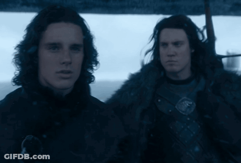 Two Men Are Standing Next To Each Other In A Dark Room GIF