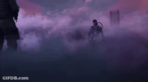 Two Men Are Standing Next To Each Other In A Dark Room Surrounded By Smoke . GIF