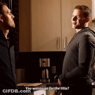 Two Men Are Standing Next To Each Other In A Kitchen And Talking . GIF