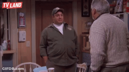 Two Men Are Standing Next To Each Other In A Kitchen . GIF