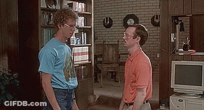 Two Men Are Standing Next To Each Other In A Living Room With A Computer In The Background . GIF