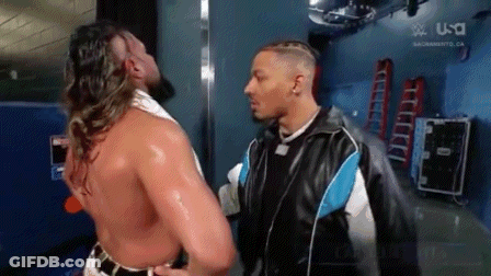 Two Men Are Standing Next To Each Other In A Locker Room . GIF