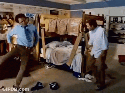 Two Men Are Standing Next To Each Other In A Messy Room With A Bunk Bed . GIF