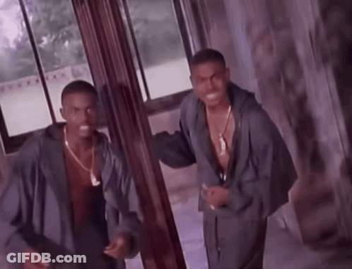 Two Men Are Standing Next To Each Other In A Room GIF