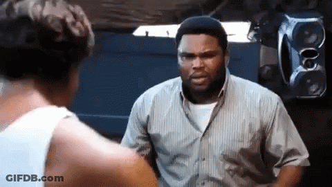 Two Men Are Standing Next To Each Other In A Room . GIF