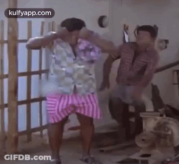Two Men Are Standing Next To Each Other In A Room And Dancing . GIF