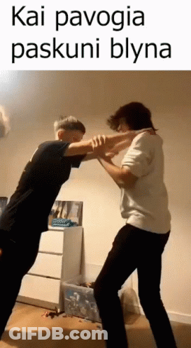 Two Men Are Standing Next To Each Other In A Room And Fighting Each Other . GIF