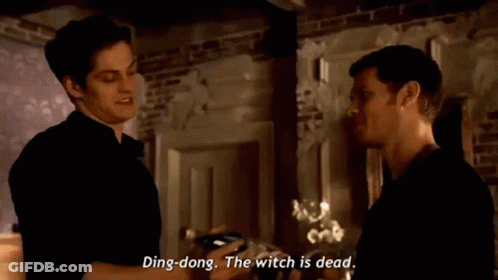 Two Men Are Standing Next To Each Other In A Room And One Of Them Is Saying Ding Dong The Witch Is Dead GIF