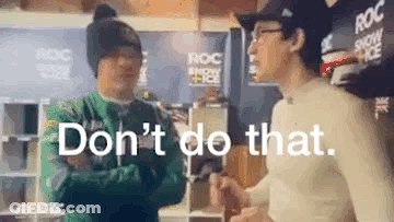 Two Men Are Standing Next To Each Other In A Room And One Of Them Is Talking To The Other . GIF