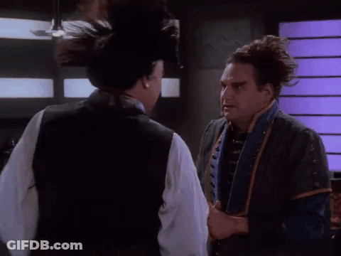 Two Men Are Standing Next To Each Other In A Room And One Of Them Is Talking To The Other . GIF