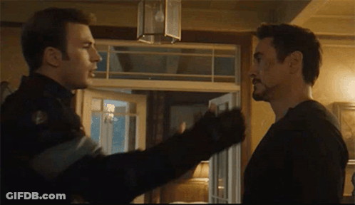 Two Men Are Standing Next To Each Other In A Room And Talking . GIF