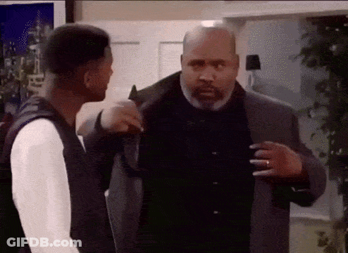 Two Men Are Standing Next To Each Other In A Room And Talking To Each Other . GIF