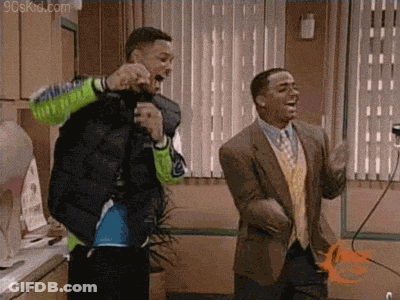 Two Men Are Standing Next To Each Other In A Room Dancing . GIF