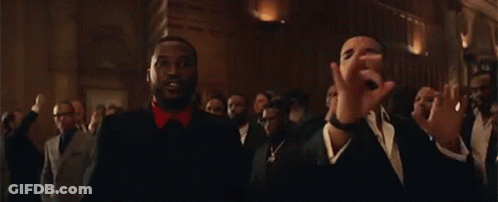 Two Men Are Standing Next To Each Other In A Room . GIF
