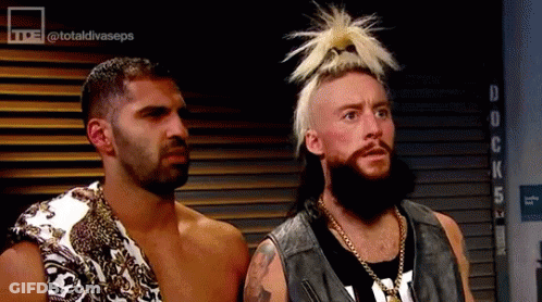 Two Men Are Standing Next To Each Other In A Room . One Of The Men Has A Ponytail On His Head . GIF