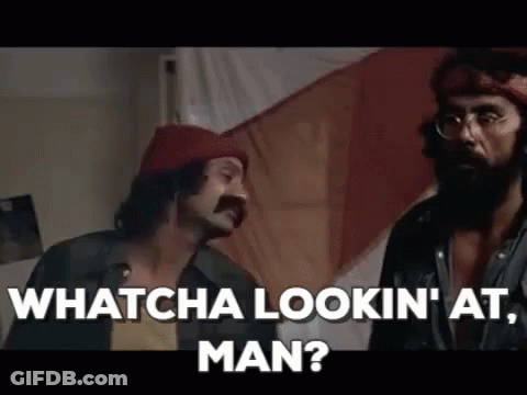 Two Men Are Standing Next To Each Other In A Room Talking To Each Other . GIF
