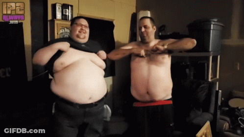 Two Men Are Standing Next To Each Other In A Room With A Jack Daniels Sign On The Wall GIF