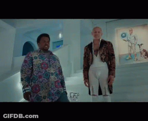Two Men Are Standing Next To Each Other In A Room With Chinese Characters On The Wall . GIF