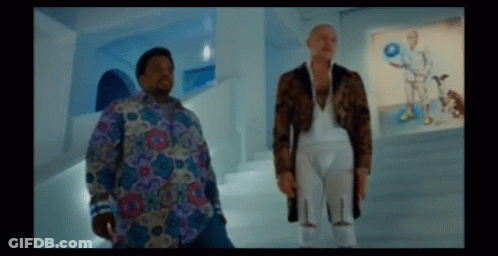 Two Men Are Standing Next To Each Other In A Room With Pictures On The Wall GIF