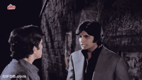 Two Men Are Standing Next To Each Other In Front Of A Brick Wall With A Sign That Says Ultra GIF