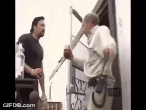 Two Men Are Standing Next To Each Other In Front Of A Building . One Of The Men Is Holding A Ladder . GIF