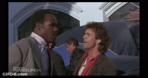 Two Men Are Standing Next To Each Other In Front Of A Building With The Words Fandango Movieclips On The Bottom GIF
