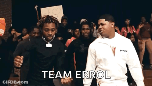 Two Men Are Standing Next To Each Other In Front Of A Crowd Of People And Holding Hands . GIF