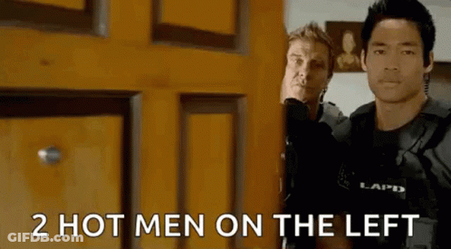 Two Men Are Standing Next To Each Other In Front Of A Door . GIF