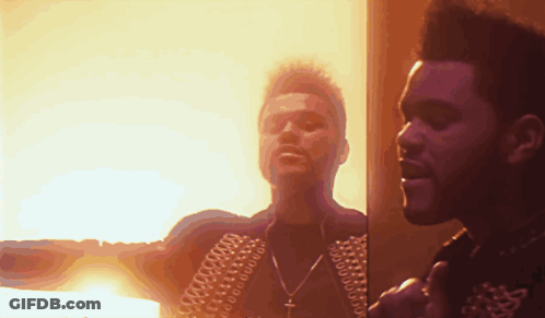 Two Men Are Standing Next To Each Other In Front Of A Fire GIF