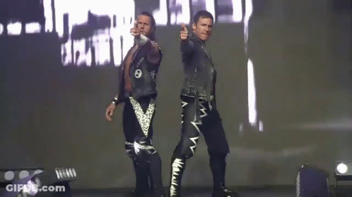 Two Men Are Standing Next To Each Other In Front Of A Large Screen With The Word Death On It GIF