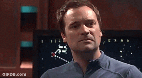Two Men Standing Next To Screen Pointing GIF