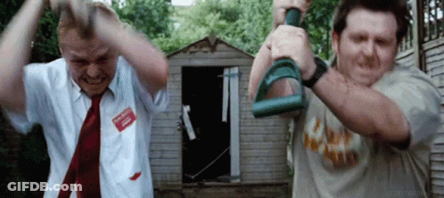 Two Men Are Standing Next To Each Other In Front Of A Shed Holding Dumbbells In Their Hands . GIF