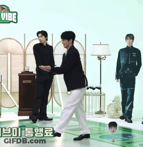 Two Men Are Standing Next To Each Other In Front Of A Sign That Says Vibe On It GIF