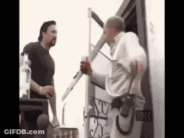 Two Men Are Standing Next To Each Other In Front Of A Trailer . GIF