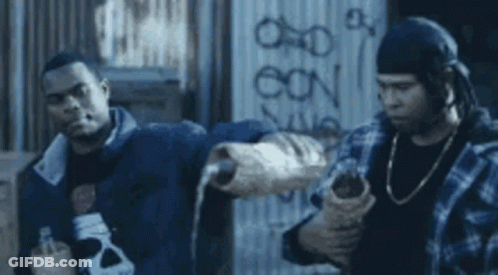 Two Men Are Standing Next To Each Other In Front Of A Wall . GIF