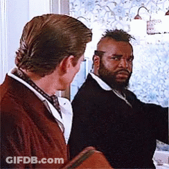 Two Men Are Standing Next To Each Other In Front Of A Window . One Has A Beard And The Other Has A Mohawk . GIF